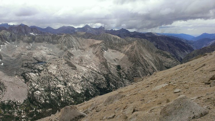 Looking northwest at fresh hail far below from near the junction of the SE Ridge and University Shoulder routes just below the summit of University Peak