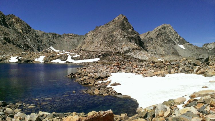 I stepped down the scree slope and then scrambled down talus to the north edge of the lake immediately below Gould Pass.