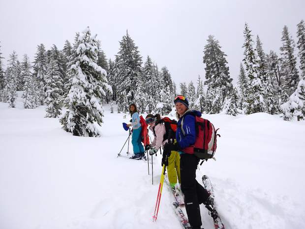 A family of delighted skiers enjoys the backcountry at Castle Valley.