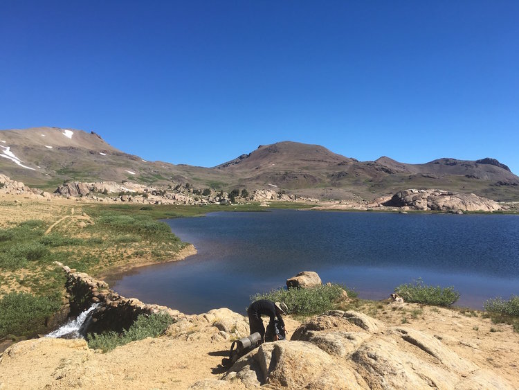 Watering up at High Emigrant Lake, Big Sam looms in the background.