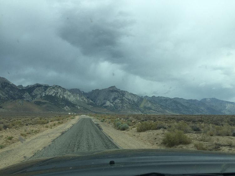 Horseshoe Meadows Road with Lone Pine Peak and Langley shrouded in dark storm clouds.