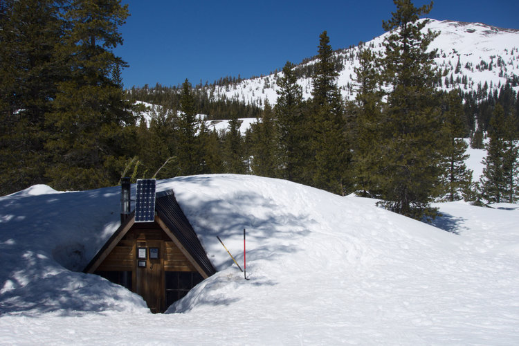 The Peter Grubb Hut is buried under a 25-foot snow drift.