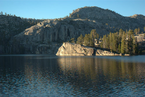 Distinctive triangular cliff jutting out from the E shore.