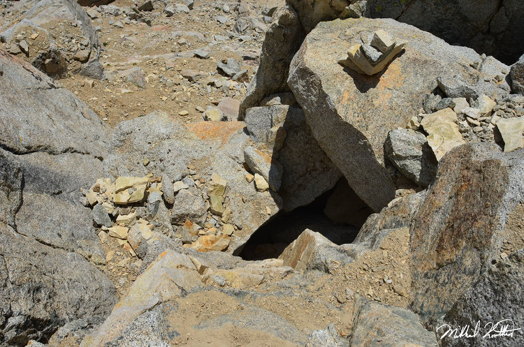 Yes you literally squeeze through that small opening in the rocks. One of the most interesting climbing maneuvers I've ever had to do.