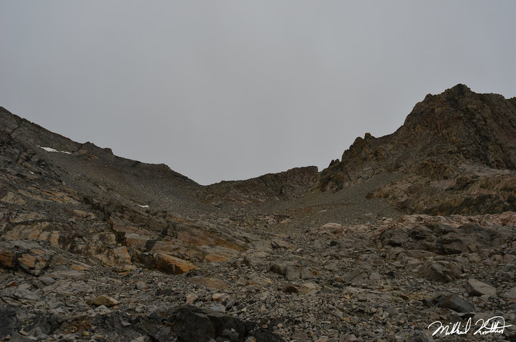 Rock salad anyone? The notch is Pants Pass. Notice how ominous and dark the sky is... this is not long before the electrification.