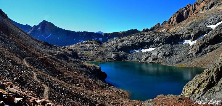 Little McGee Lake is tucked inside a world of multicolored rock and has a shade of blue almost too good to be true!