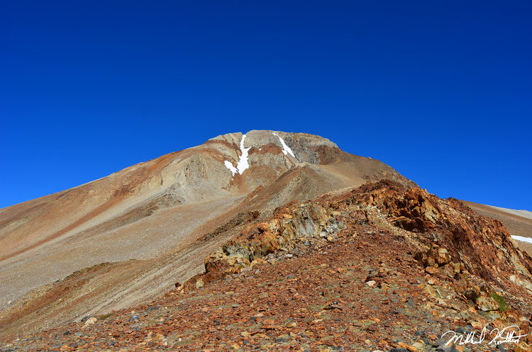 Red Slate Mtn. is not nearly as steep up close as when viewed from a distance. The route was easy but a cold wind blew! People routinely ski down the two snow couloirs seen in the photo.