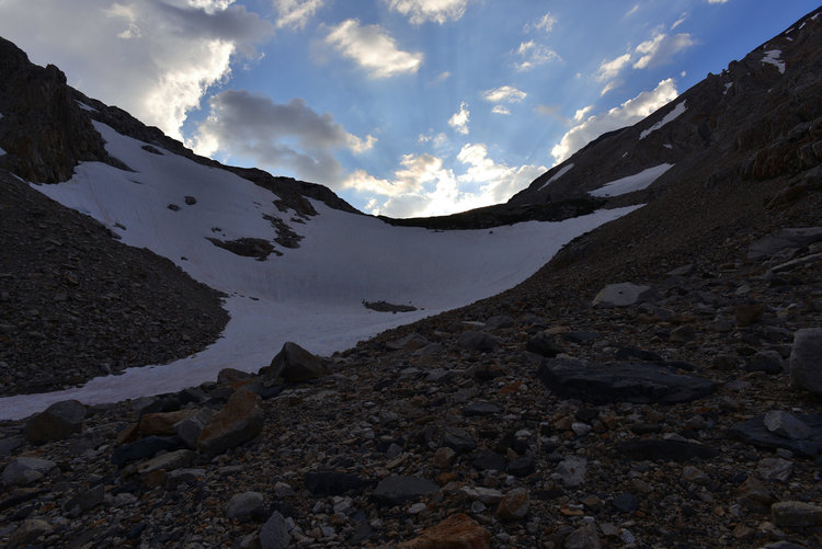 While this looks like the top of the pass it actually is just below it. At the top of this is the lake and the pass is just a little further. The clouds threatened to rain late in the day but never did anything other than sprinkle. The trail stays to the right and never had to cross the snowfield.
