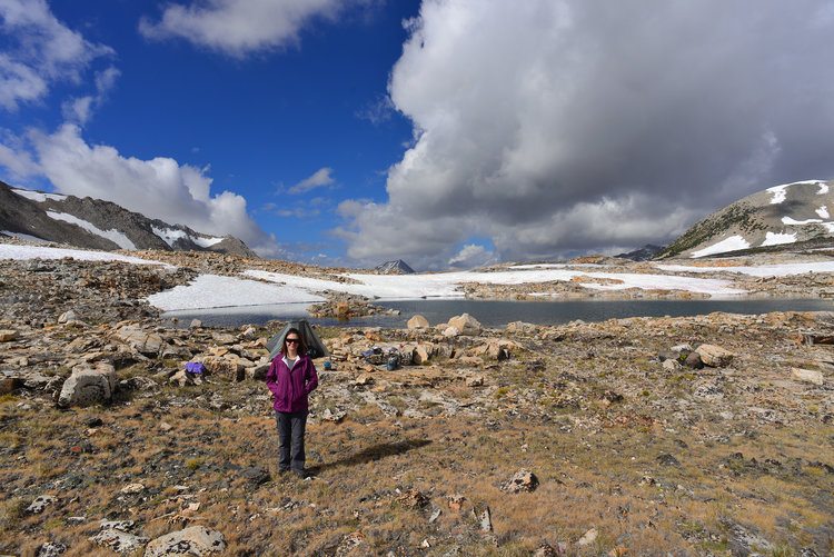 Camp along the Taboose Pass lake with clouds rolling in.