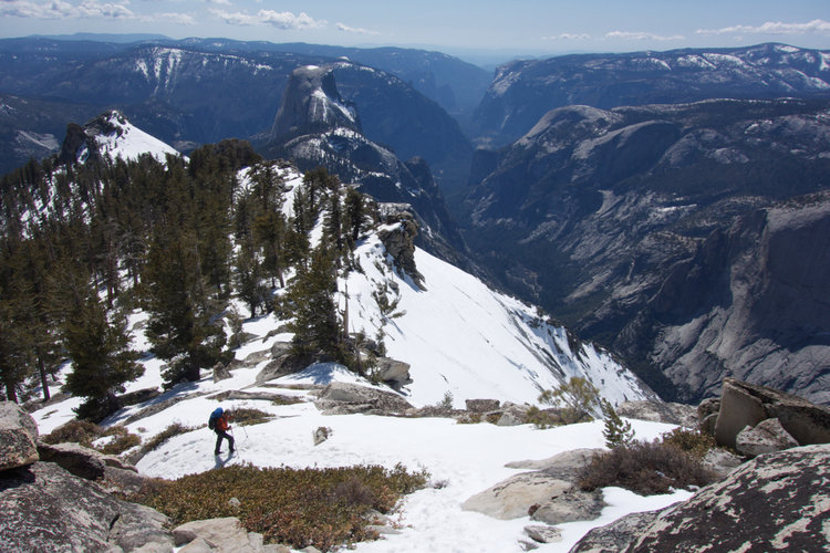 On the Clouds Rest stairs, looking towards Half Dome. Note my buddy hiking up the snow ramp below.