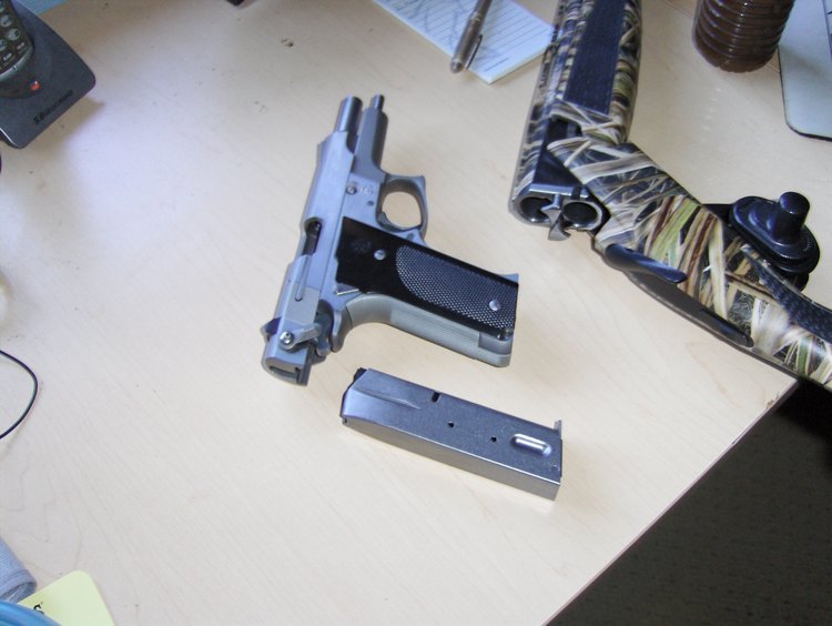 The 9mm slide is locked and the magazine is out.  Crack the 12 gauge and there aren't shells in it.