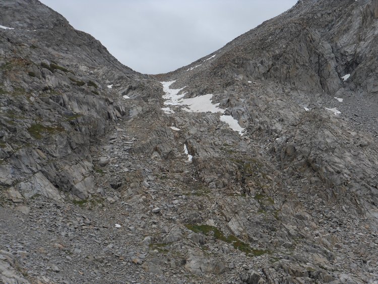 Sluggo-Ingraham Pass -- I followed wall on left to slabs halfway up, then crossed right to snow chute, followed gap between snow and rock, and climbed back out