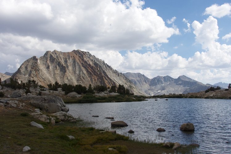 Acrodeetes Peak looms over an unnamed tarn on the south side of Pinchot Pass.