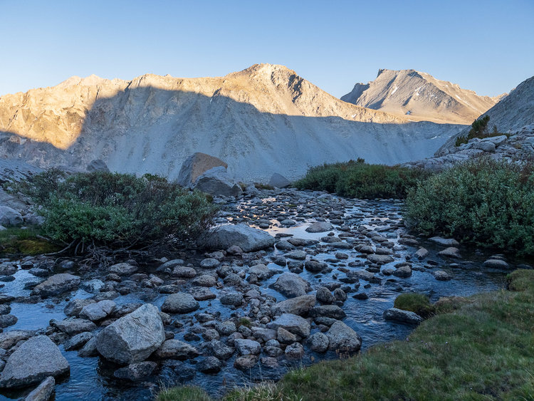 the trail will shortly take you to this very pleasant little meadow where a branch of shepherd creek emerges from under talus. stay to the right here, there's a cairn that'll take you onto the very pleasant switchbacks down