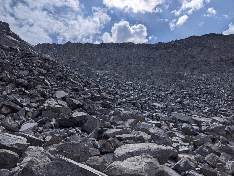 Ledges followed by the talus field on the west side. My friend is in the middle of the field - so you can judge the size of the talus.