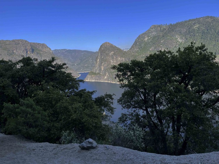 View over Hetch Hetchy to Kolana rock with some of the higher snowcapped surroundings visible.