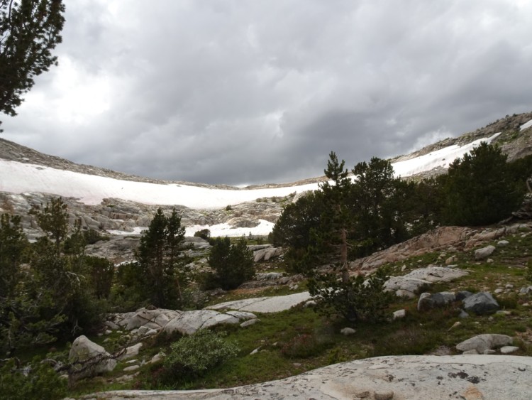 Looking up at the Pass and the threatening clouds.
