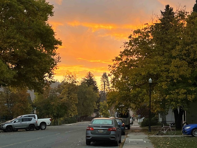 Judy captures the sunrise and the gathering clouds as well as fall colors on a backstreet of Quincy.