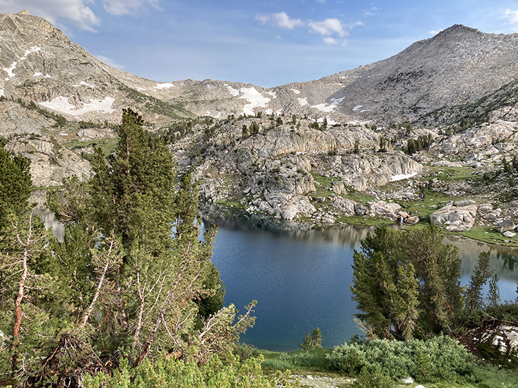 View from above the north shore of Tully Lake (after the rain storm).  Shout-of-Relief Pass and Rohn Pass are in the distance.