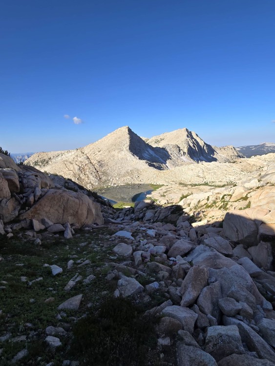 looking down at lake below mantle pass and our two peaks behind it