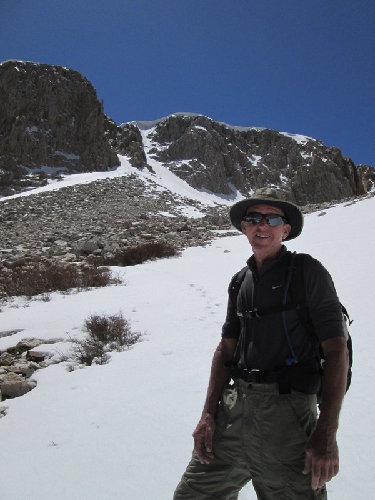 John below a cornice