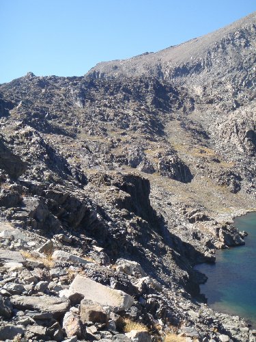 Lake 11,951’ is surrounded by complicated topography.   We dropped into the cirque from the upper right of the photo (below that huge shoulder of Mt. Goddard).  After descending nearly to the shore, we had to work our way above the shadowed cliffs that drop directly into the lake.